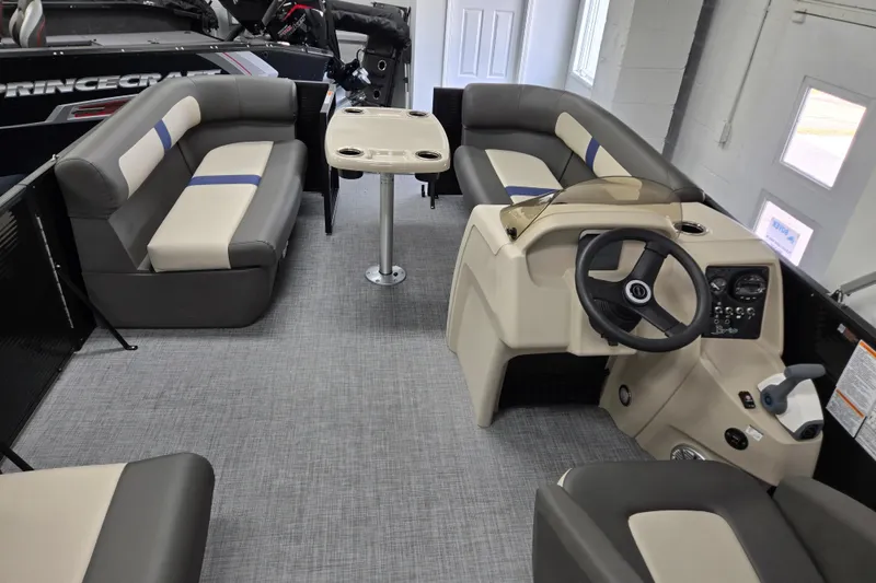 Slide: The Image of 2026 Princecraft Brio 17 Electric pontoon boat interior with seating and steering console. - 12