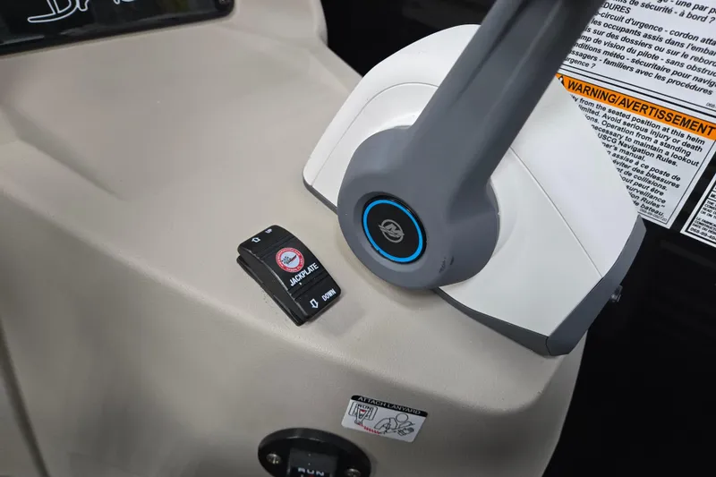 Slide: The Image of Control panel of 2026 Princecraft Brio 17 Electric boat with jackplate switch and warning label. - 9