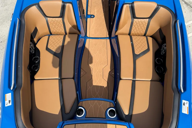 Slide: The Image of 2026 Yamaha Boats 255XD interior with tan and black seating, blue accents, and cup holders. - 11