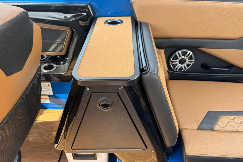 Slide: The Image of Interior of 2026 Yamaha Boats 255XD, featuring tan and black seating with integrated speaker. - 17