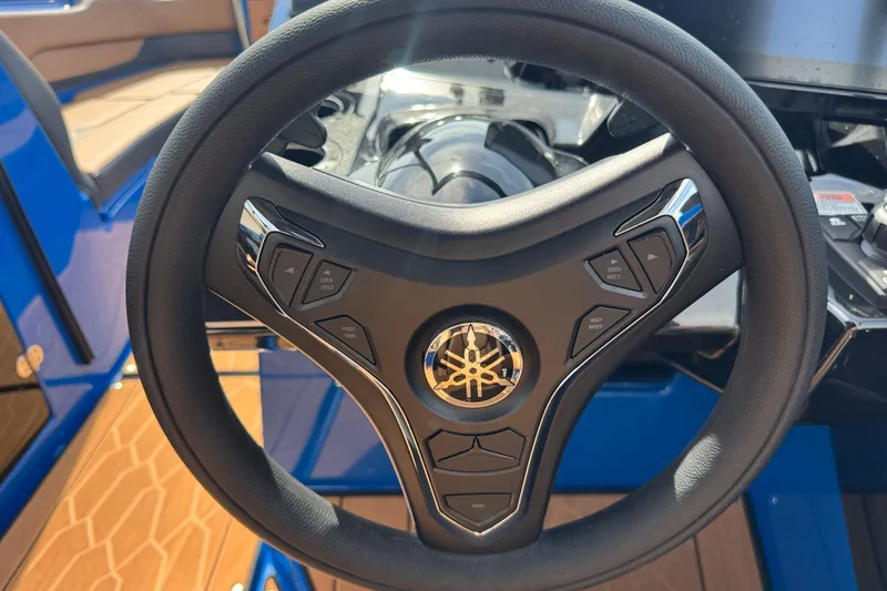 Slide: The Image of Steering wheel of 2026 Yamaha Boats 255XD, featuring control buttons and sleek design. - 24