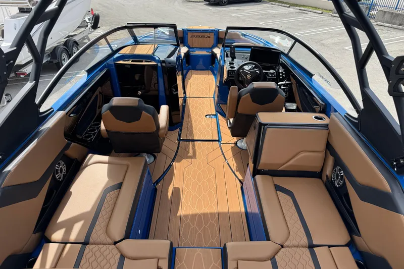 Slide: The Image of 2026 Yamaha Boats 255XD interior with tan seating and modern dashboard design. - 6