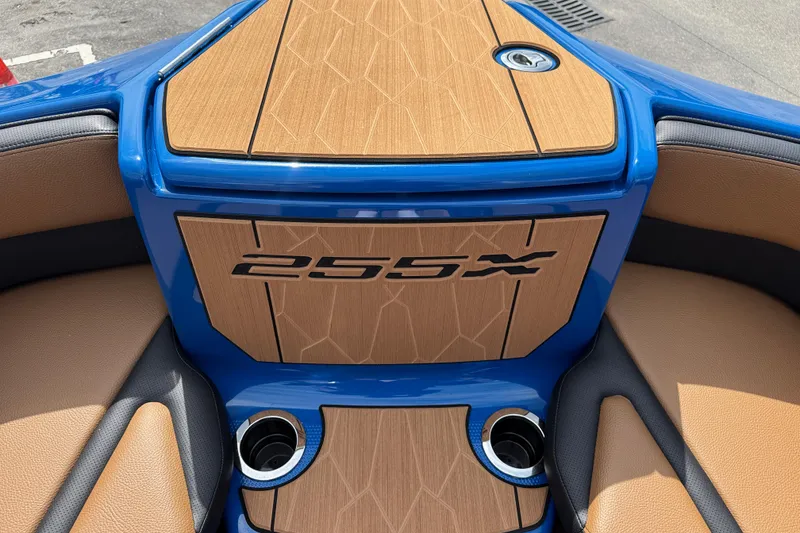 Slide: The Image of 2026 Yamaha Boats 255XD interior with sleek wood finish and cup holders. - 9