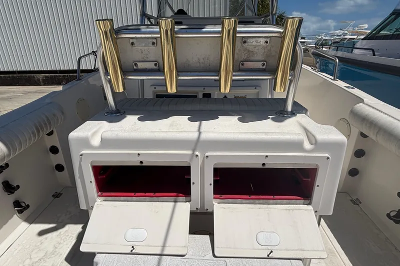 Slide: The Image of 2003 Robalo R230 Center Console boat with rod holders and storage compartments. - 10