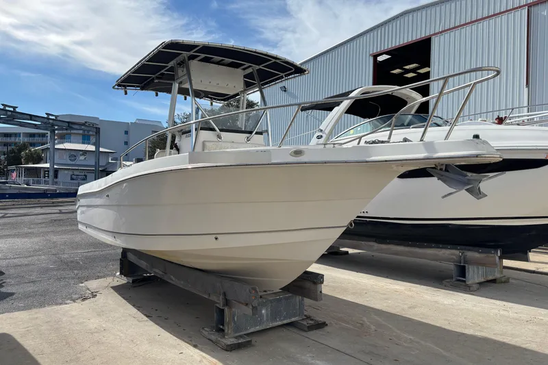 Slide: The Image of 2003 Robalo R230 Center Console boat on a dry dock. - 3