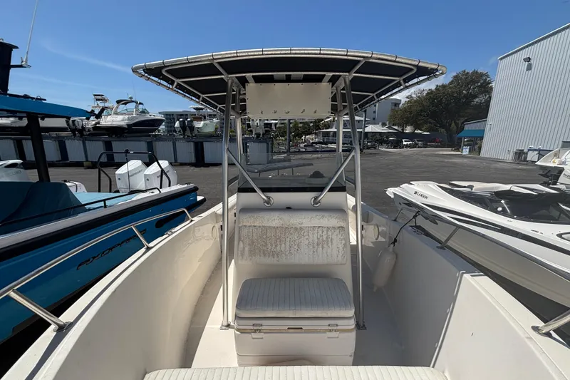 Slide: The Image of 2003 Robalo R230 Center Console boat with T-top in marina setting. - 6