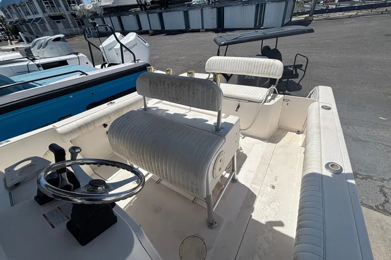 Slide: The Image of 2003 Robalo R230 Center Console boat interior with steering wheel and seating. - 9