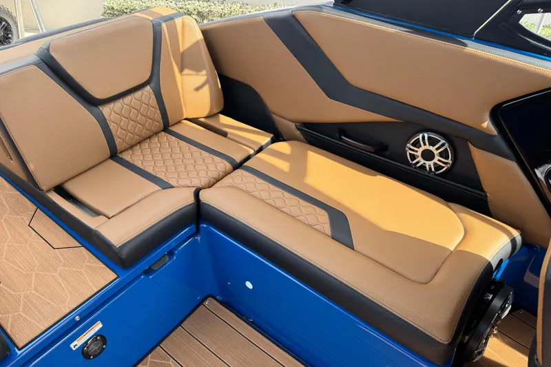 Slide: The Image of 2026 Yamaha Boats 255XD interior with tan and black seating, featuring a speaker. - 14