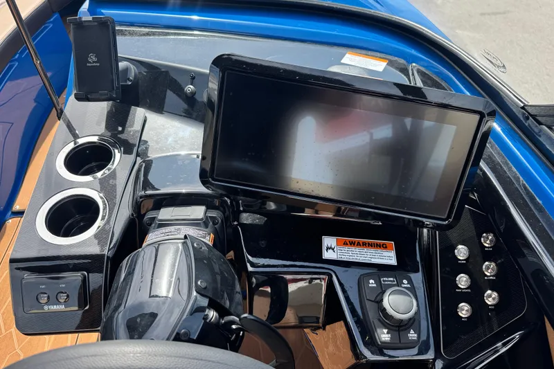 Slide: The Image of 2026 Yamaha Boats 255XD dashboard with touchscreen, controls, and cup holders. - 23