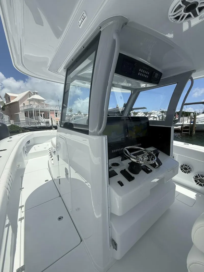 Slide: The Image of Modern Freeman 38 boat cockpit with advanced controls, docked near waterfront homes, 2026 model. - 10