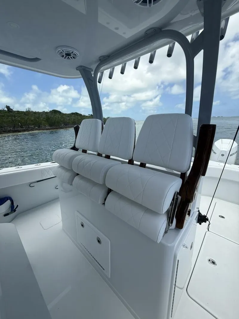 Slide: The Image of Luxury seating on a 2026 Freeman 38 boat, featuring white cushioned seats and sleek design. - 13
