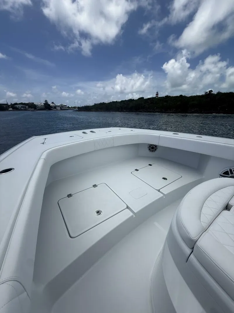 Slide: The Image of 2026 Freeman 38 boat deck with seating, under a partly cloudy sky. - 15