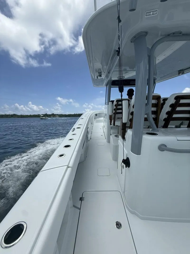 Slide: The Image of 2026 Freeman 38 boat cruising on open water under a clear blue sky. - 18