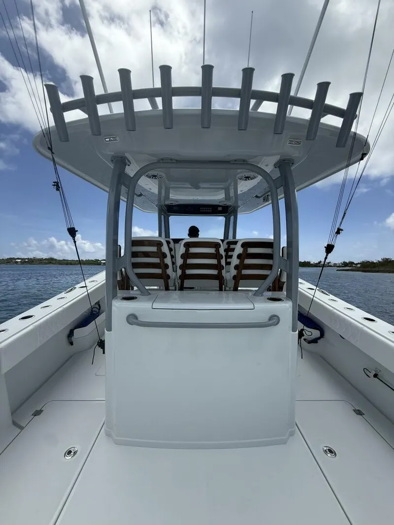 Slide: The Image of 2026 Freeman 38 boat with spacious deck and seating, under a clear blue sky. - 19