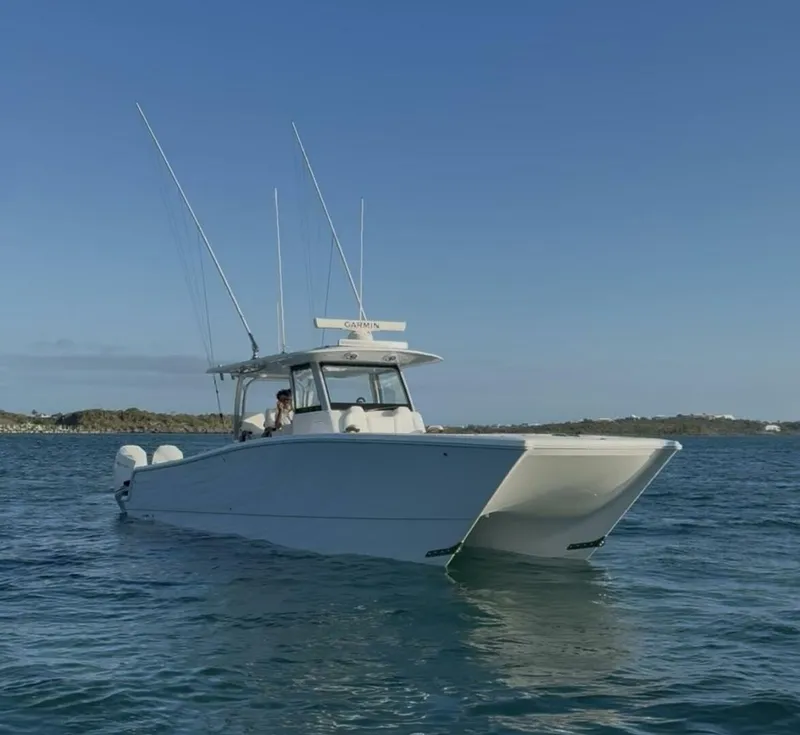 Slide: The Image of 2026 Freeman 38 boat on calm water under clear blue sky. - 2
