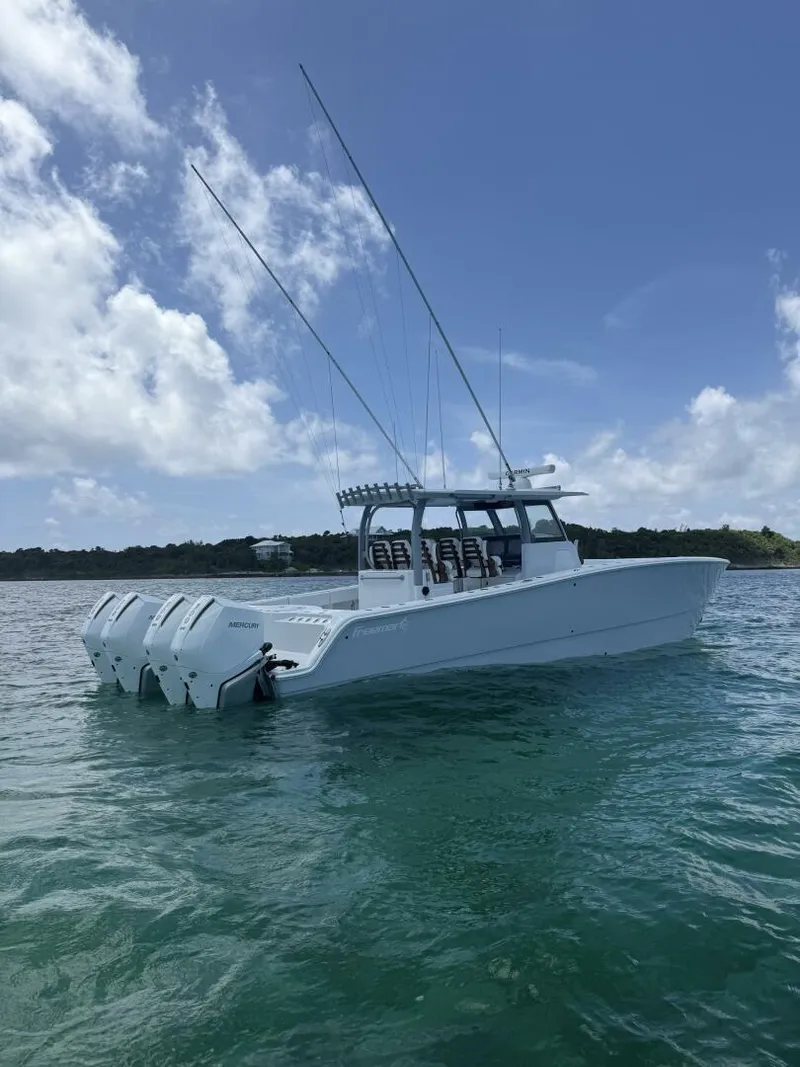 Slide: The Image of 2026 Freeman 38 boat with multiple outboard engines on calm water under blue sky. - 5