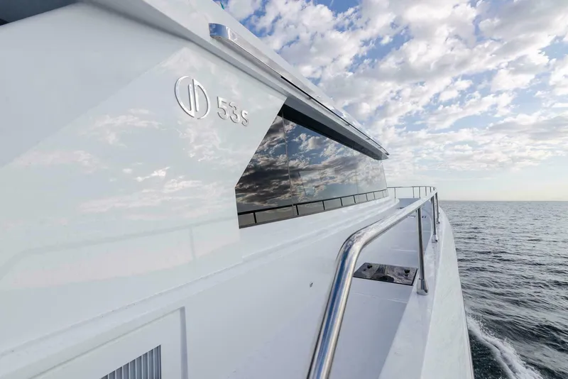 Slide: The Image of Luxury ILIAD 53S yacht cruising on open sea under a cloudy sky, 2026 model. - 24