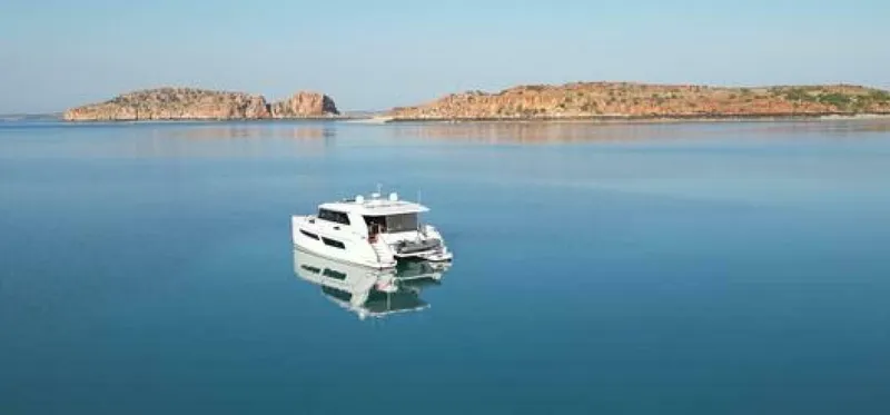 Slide: The Image of Luxury ILIAD 53S yacht on serene waters, 2026 model, with scenic island backdrop. - 21