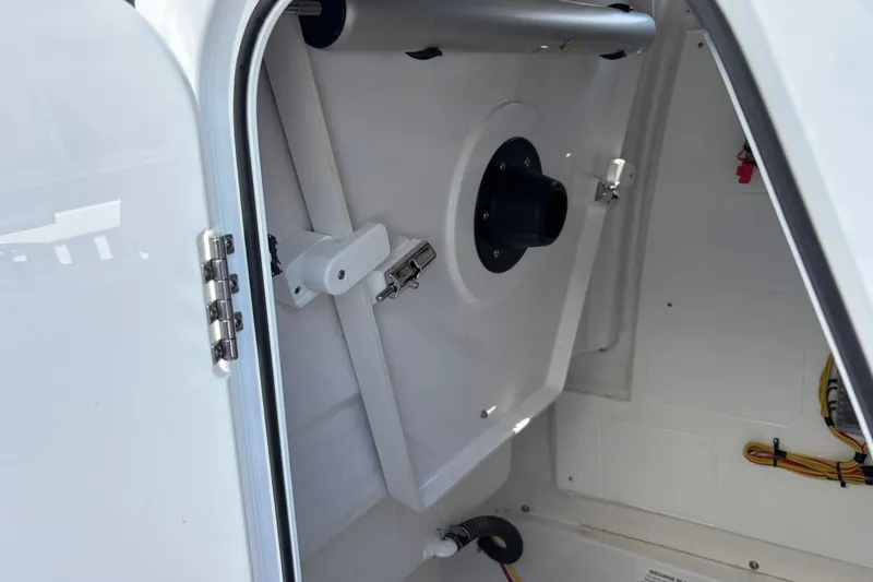 Slide: The Image of 2025 Sportsman Heritage 231 Center Console interior compartment with wiring and secure latch. - 13