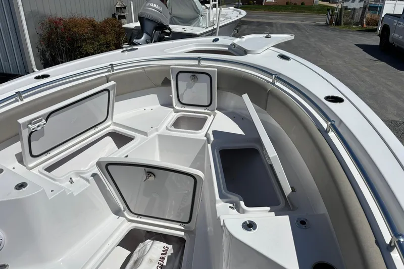 Slide: The Image of 2025 Sportsman Heritage 231 Center Console boat with open storage compartments. - 18