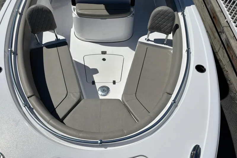 Slide: The Image of 2025 Sportsman Heritage 231 Center Console boat with cushioned seating and sleek design. - 19