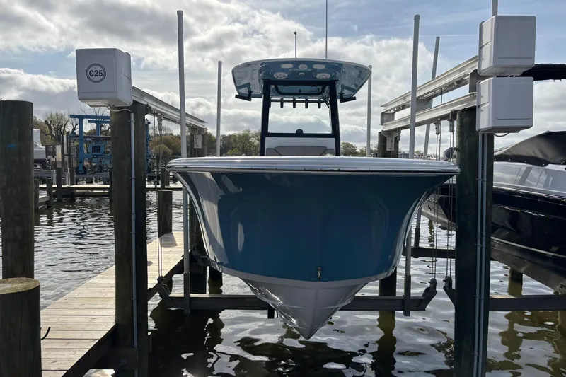 Slide: The Image of 2025 Sportsman Heritage 231 Center Console boat docked at marina, front view. - 21