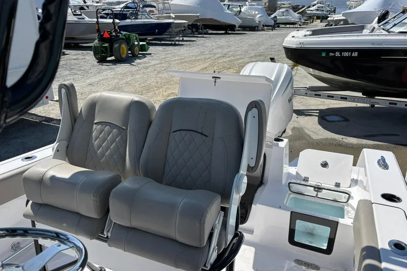 Slide: The Image of 2025 Sportsman Heritage 231 Center Console boat with dual seats and outboard motor. - 6