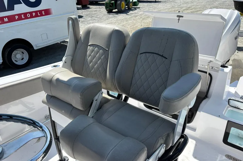 Slide: The Image of 2025 Sportsman Heritage 231 Center Console boat seats with diamond stitching and armrests. - 7