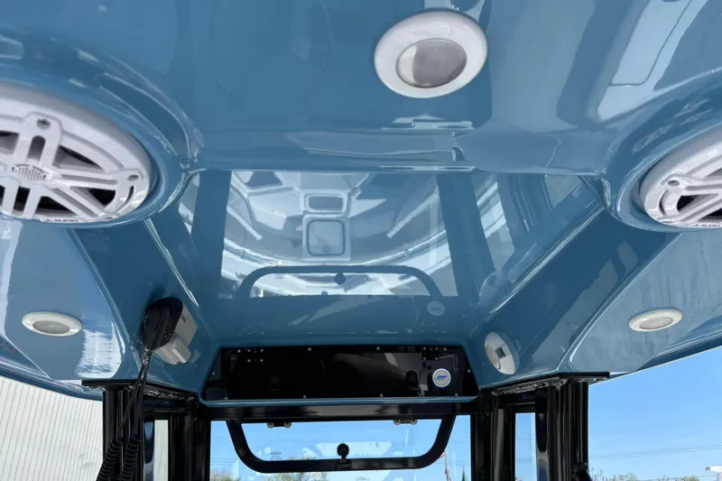 Slide: The Image of 2025 Sportsman Heritage 231 Center Console interior with speakers and blue finish. - 9