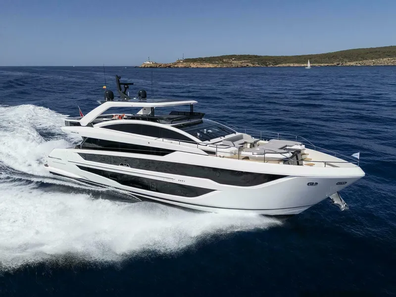 The Image of Luxurious 2026 Pearl 82 yacht cruising on open sea under clear blue sky. - 1