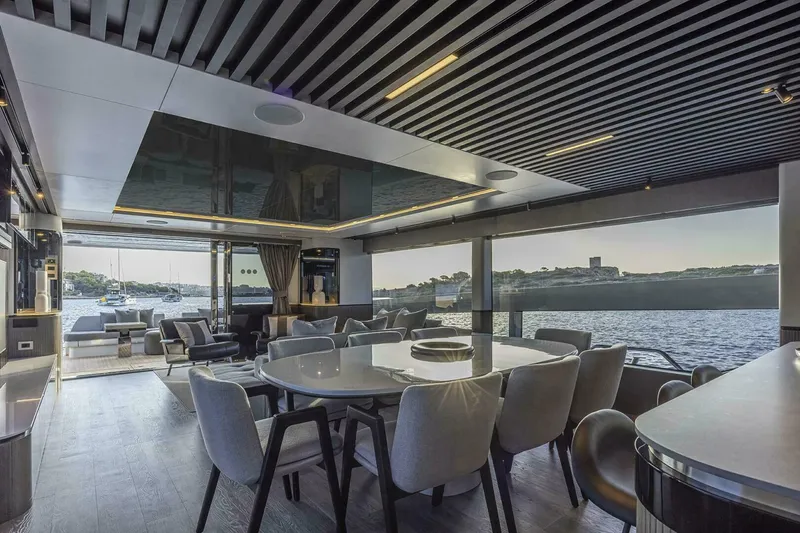 Slide: The Image of Luxurious interior of 2026 Pearl 82 yacht with elegant dining area and scenic ocean view. - 15