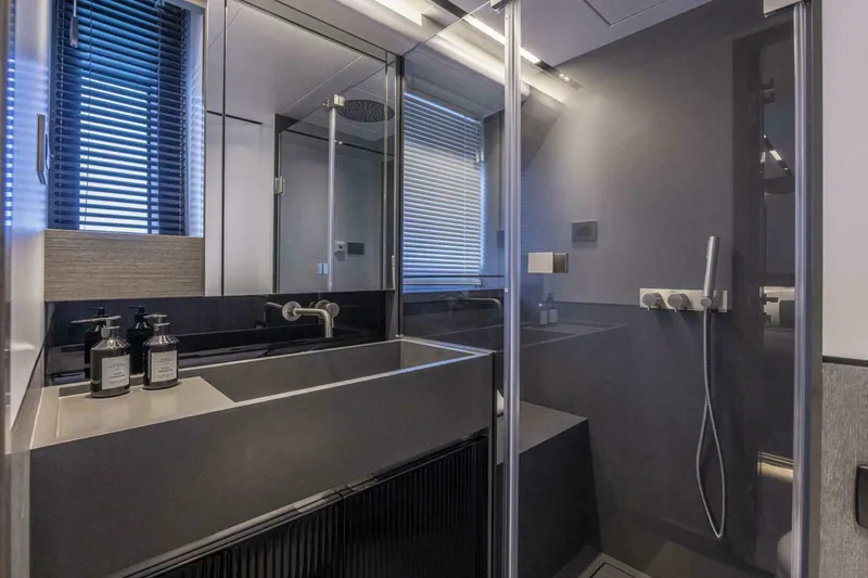 Slide: The Image of Modern bathroom with sleek design, featuring a glass shower and contemporary fixtures in a Pearl 82 yacht. - 31