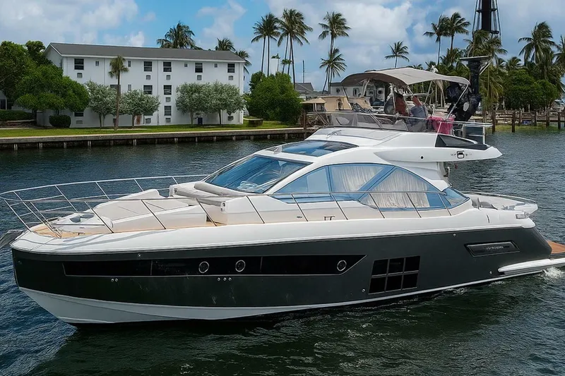The Image of 2023 Azimut S6 Sport-Fly yacht cruising on a scenic waterway with palm trees. - 2