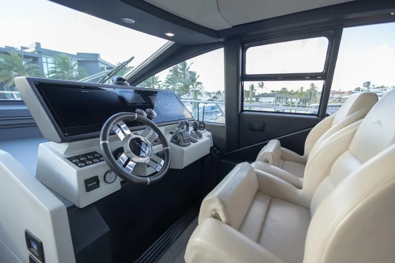 Slide: The Image of 2023 Azimut S6 Sport-Fly yacht cockpit with modern steering and luxurious seating. - 24