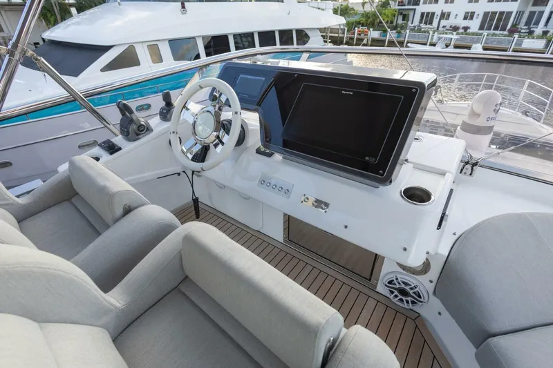 Slide: The Image of 2023 Azimut S6 Sport-Fly yacht helm with modern controls and plush seating. - 44