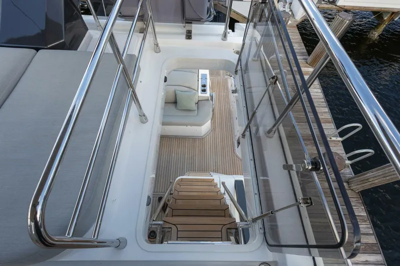 Slide: The Image of 2023 Azimut S6 Sport-Fly yacht interior with sleek stairs and modern seating area. - 49