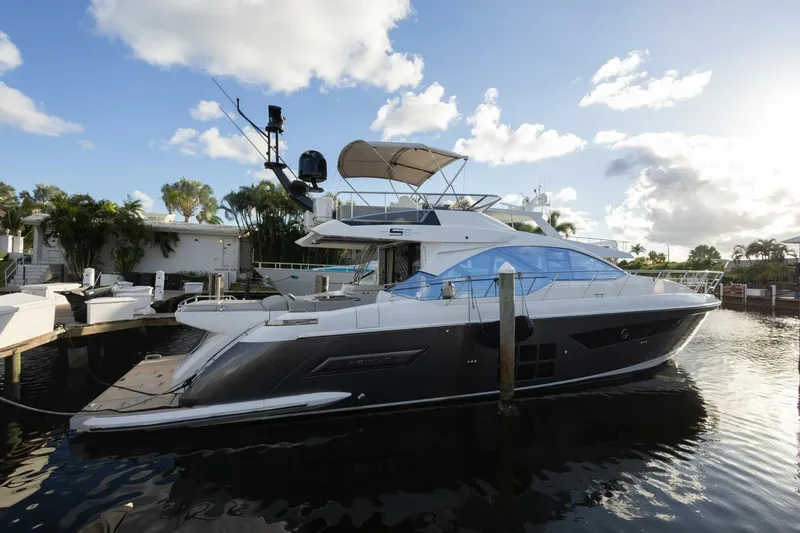 Slide: The Image of 2023 Azimut S6 Sport-Fly yacht docked in a sunny marina setting. - 6