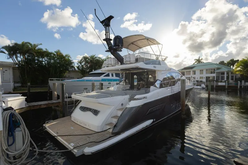 Slide: The Image of 2023 Azimut S6 Sport-Fly yacht docked in a sunny marina setting. - 7
