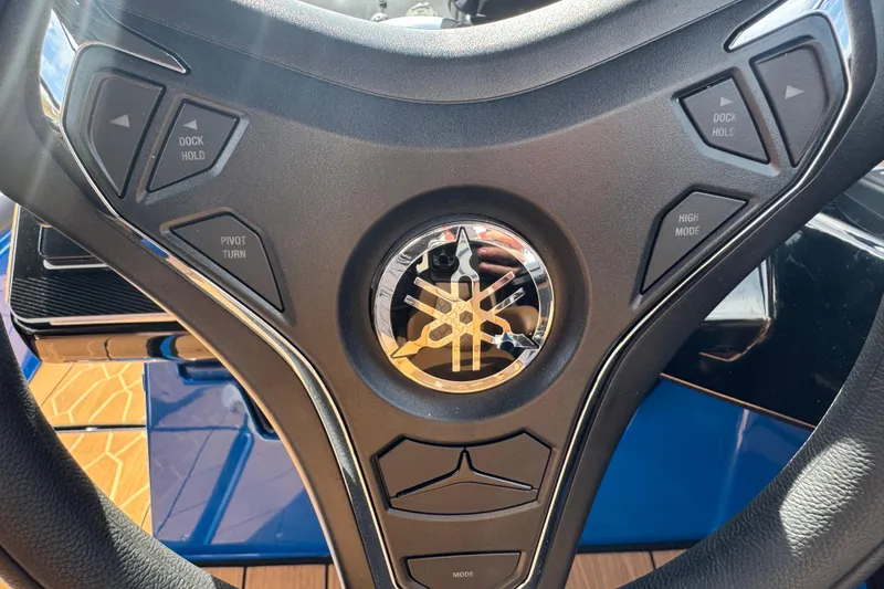 Slide: The Image of Steering wheel of 2026 Yamaha Boats 255XD with control buttons and logo. - 25