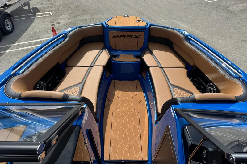 Slide: The Image of 2026 Yamaha Boats 255XD interior with tan seating and blue accents, showcasing luxury design. - 8