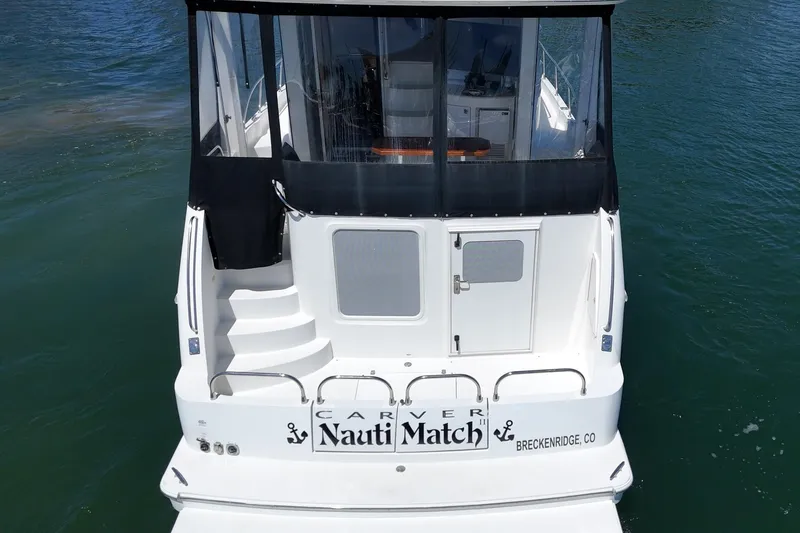 Slide: The Image of 2007 Carver 43 Motor Yacht on water, rear view with steps and enclosed deck. - 12