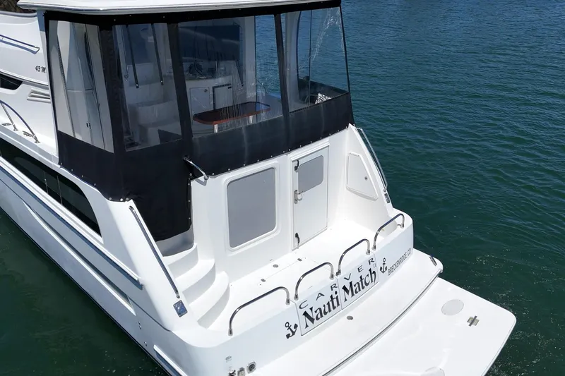 Slide: The Image of 2007 Carver 43 Motor Yacht on water, rear view with enclosed deck. - 13