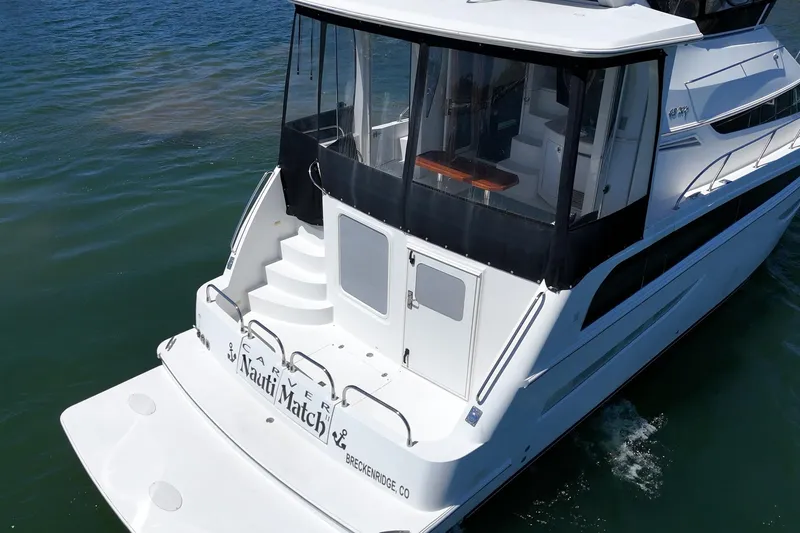 Slide: The Image of 2007 Carver 43 Motor Yacht on water, rear view with steps and enclosed deck. - 14
