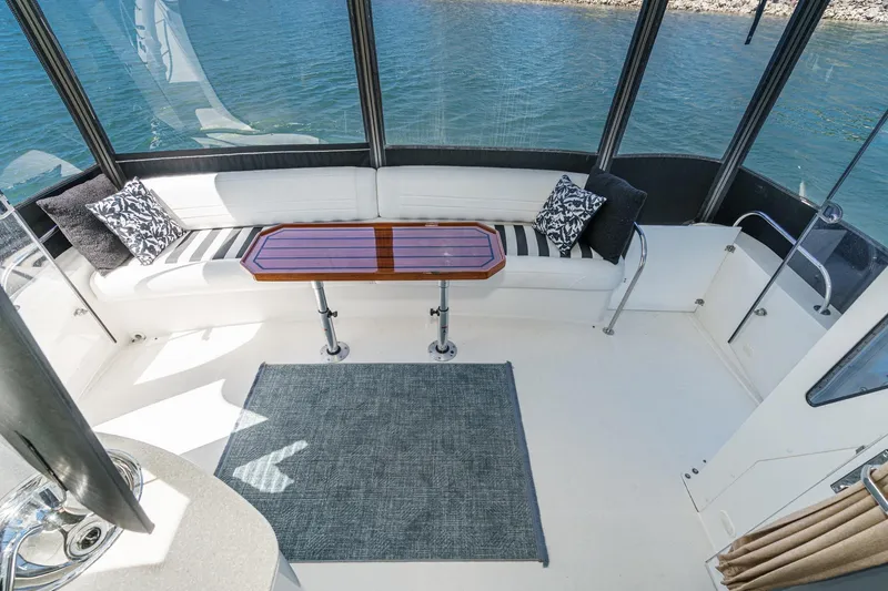 Slide: The Image of Luxurious 2007 Carver 43 Motor Yacht interior with elegant seating and scenic water view. - 15