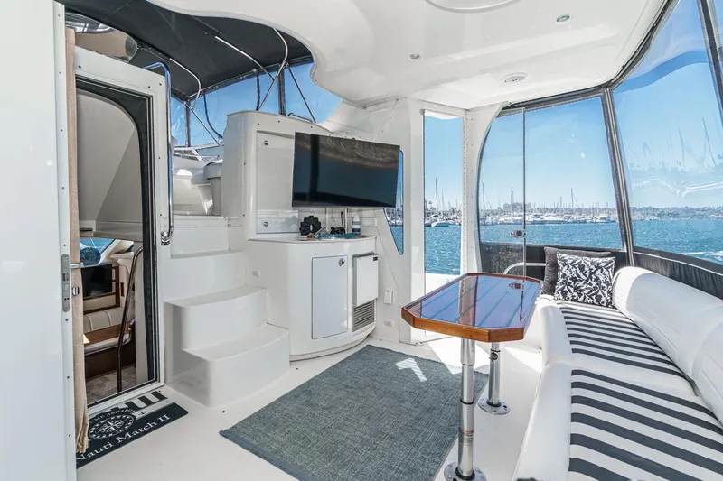 Slide: The Image of Luxurious 2007 Carver 43 Motor Yacht interior with seating, table, and ocean view. - 16