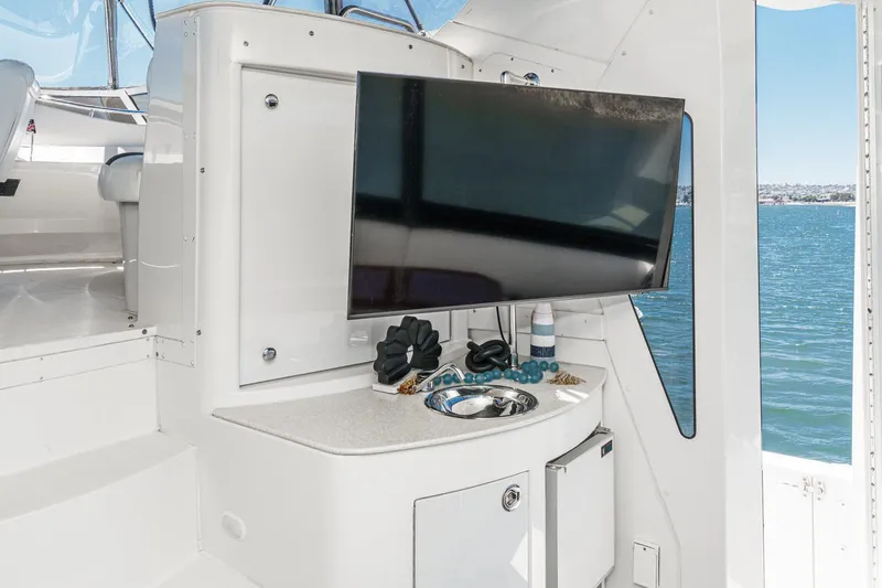 Slide: The Image of 2007 Carver 43 Motor Yacht interior with TV, sink, and ocean view. - 17
