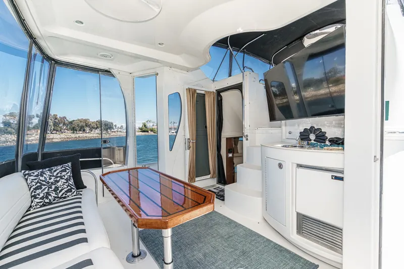 Slide: The Image of Luxurious 2007 Carver 43 Motor Yacht interior with elegant seating and scenic water views. - 19