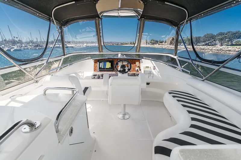 Slide: The Image of 2007 Carver 43 Motor Yacht helm with panoramic marina view and luxurious seating. - 21