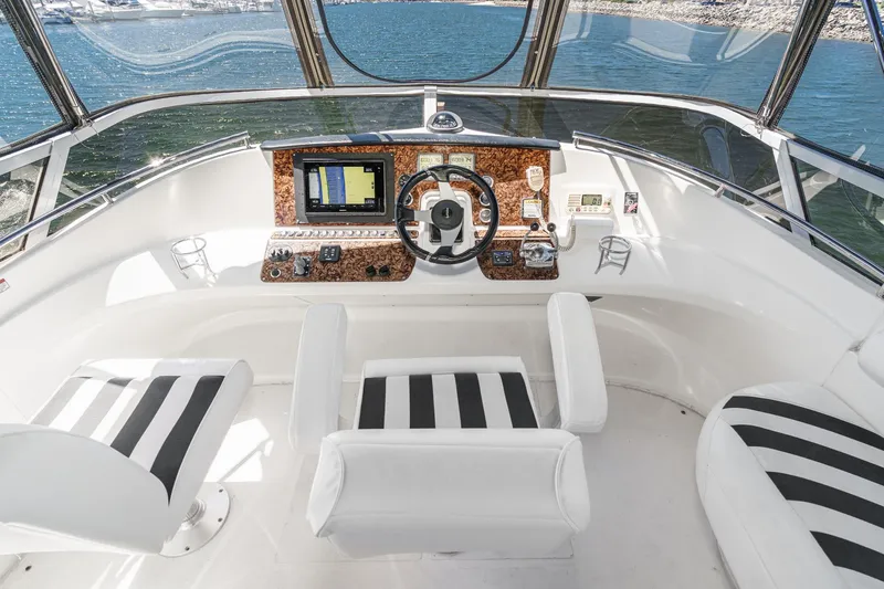 Slide: The Image of 2007 Carver 43 Motor Yacht helm with striped seating and navigation equipment. - 22