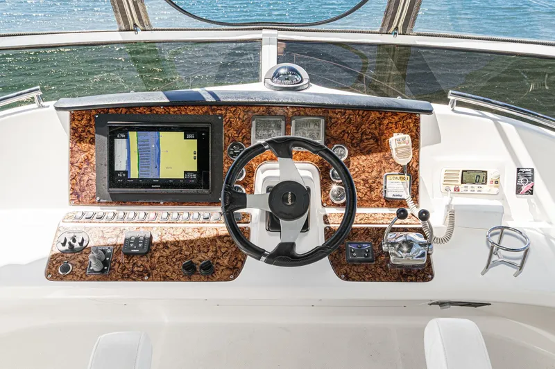 Slide: The Image of Helm of 2007 Carver 43 Motor Yacht with navigation controls and steering wheel. - 23